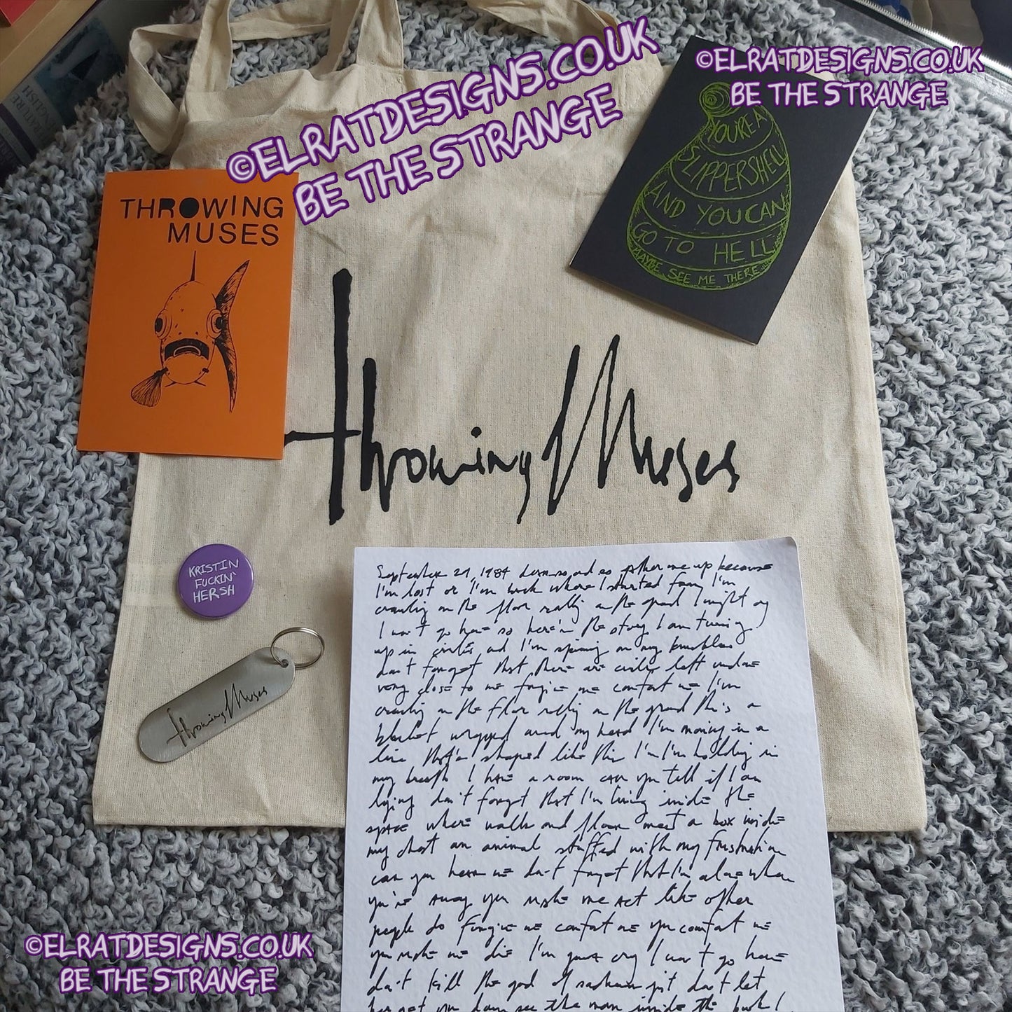 ElRat in the wild. Range of purchased tour goods. 'Throwing Muses' merchandise including a tote bag, 2 screen printed cards, keyring, Kristin Fuckin Hersh badge/button, and "The letter" - ElRat Designs - hero - elratdesigns.co.uk