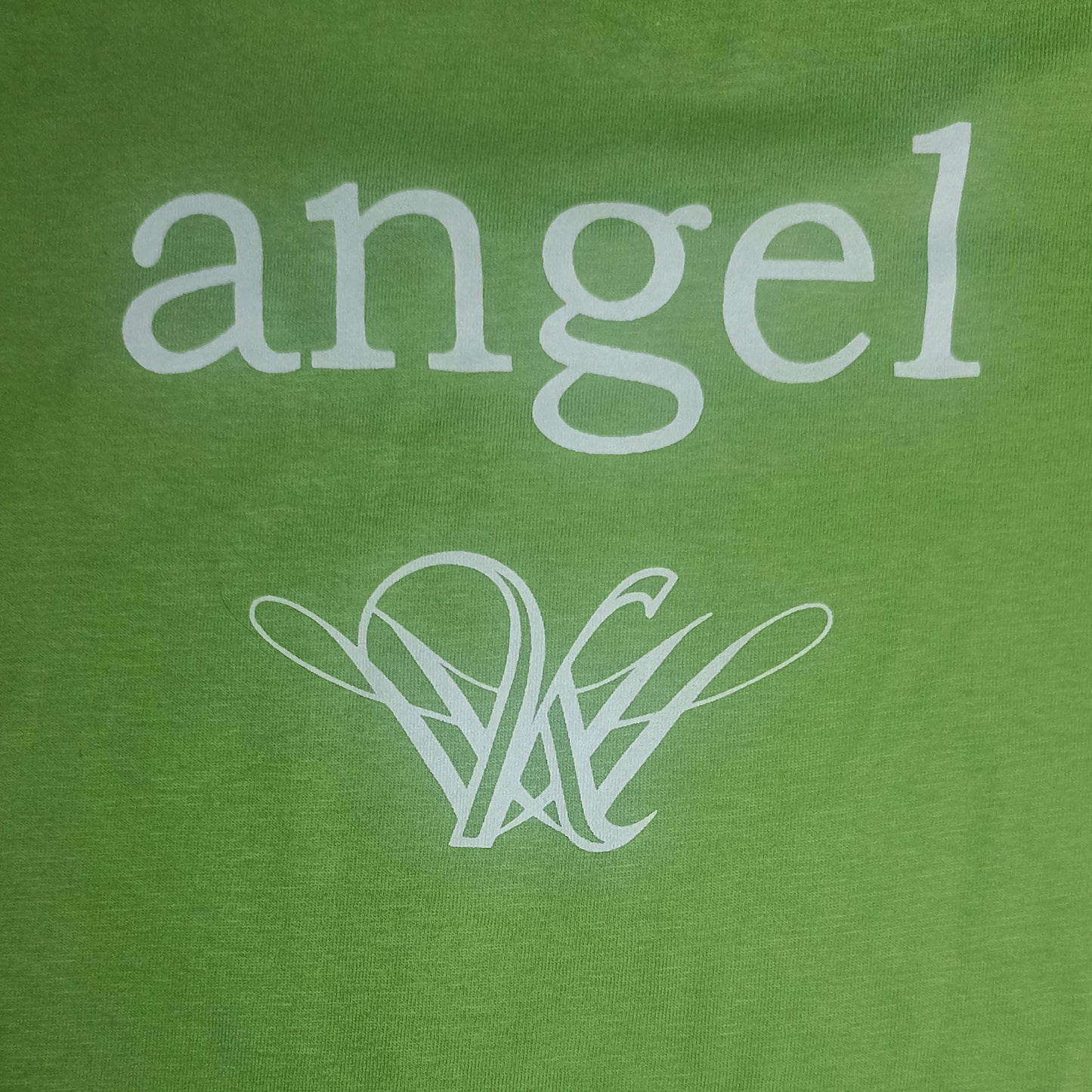 Strange Angel Exclusive Green shirt with 'angel' printed in white on a green background