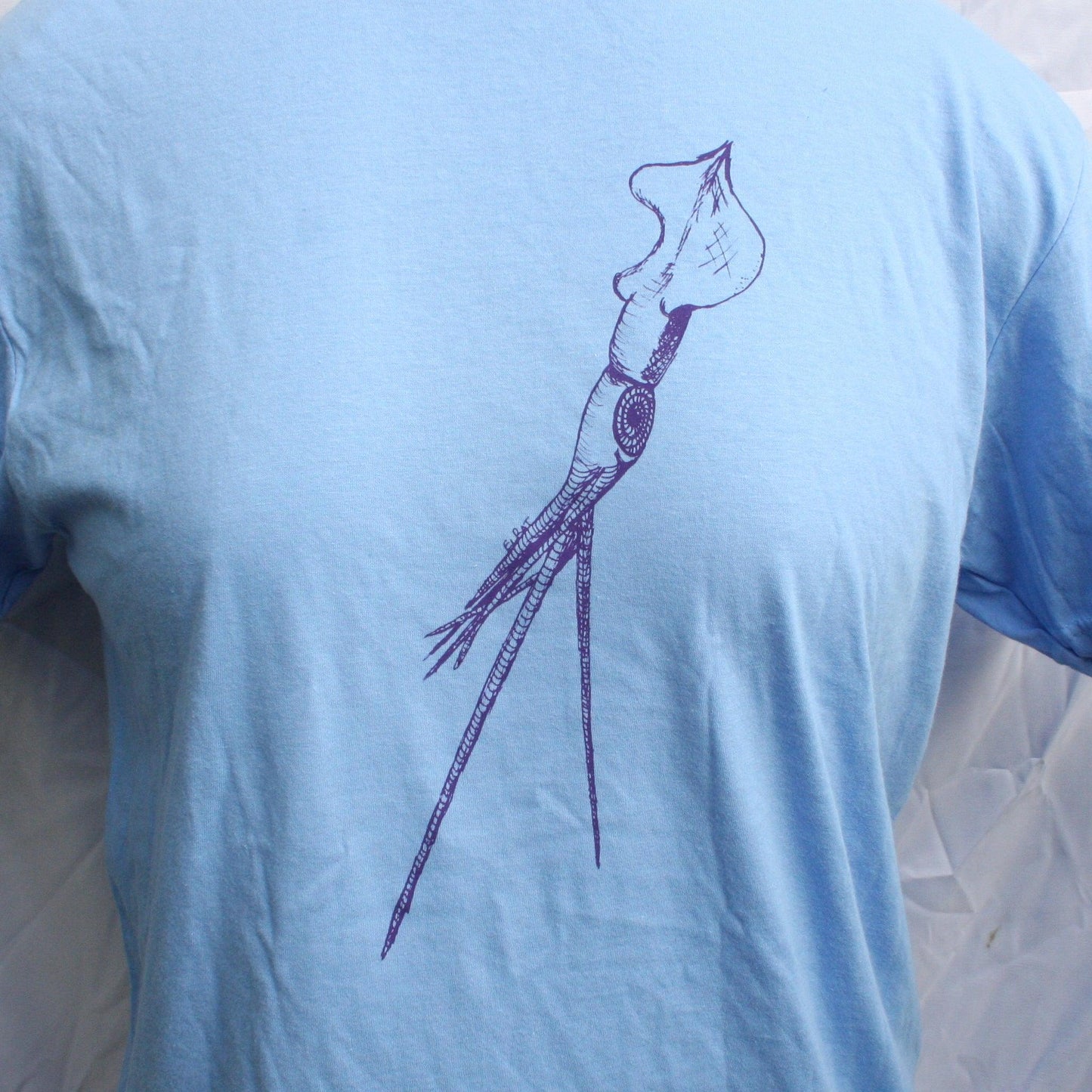 Caroline blue T-shirt featuring a hand-drawn whiplash squid design, with intricate tentacle details and artistic lines.