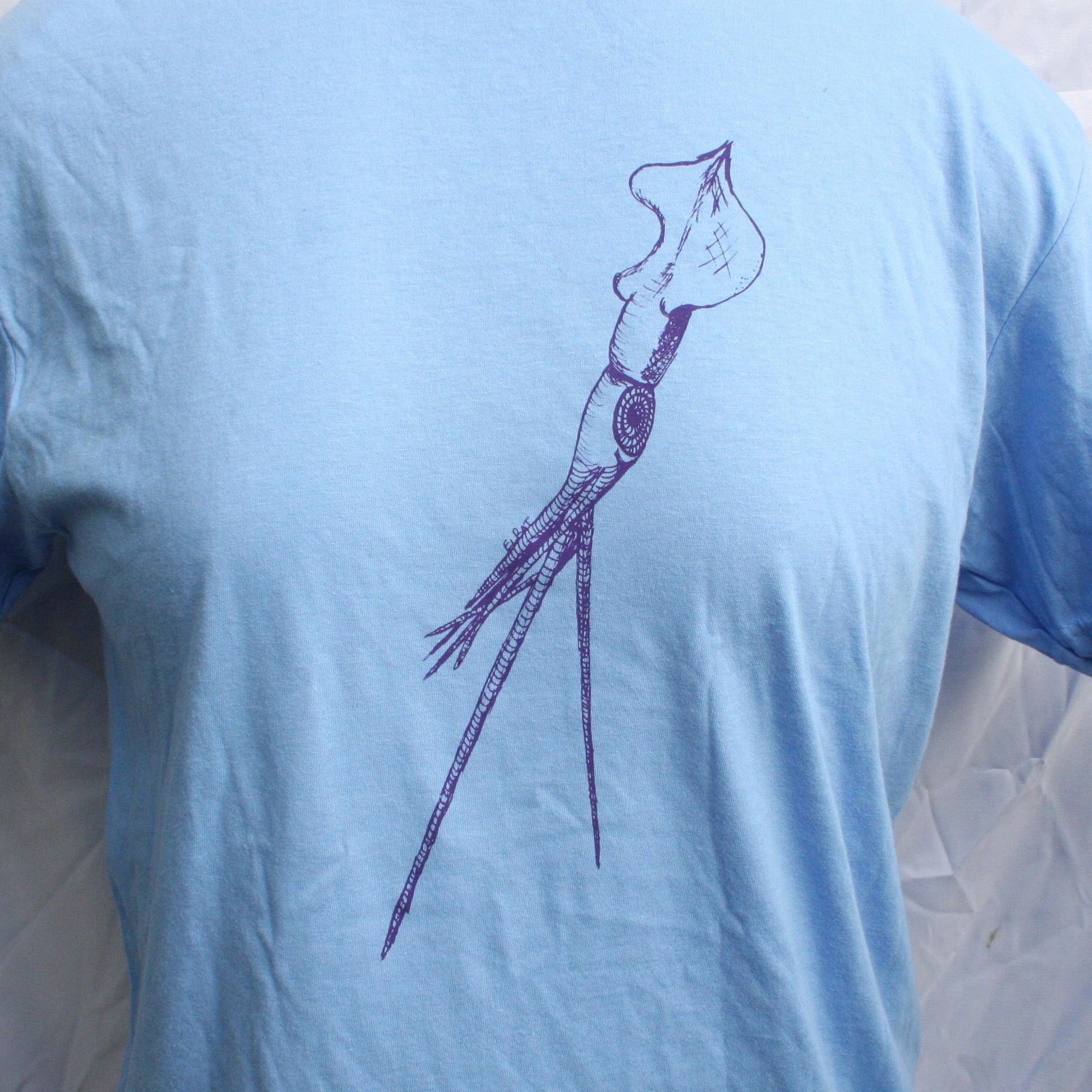 Caroline blue T-shirt featuring a hand-drawn whiplash squid design, with intricate tentacle details and artistic lines.