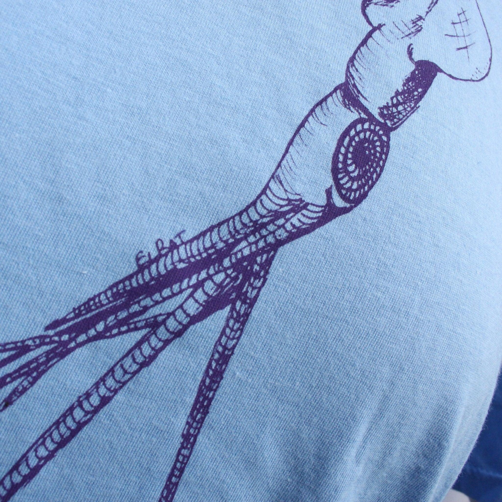 Caroline blue T-shirt featuring a hand-drawn whiplash squid design, with intricate tentacle details and artistic lines.