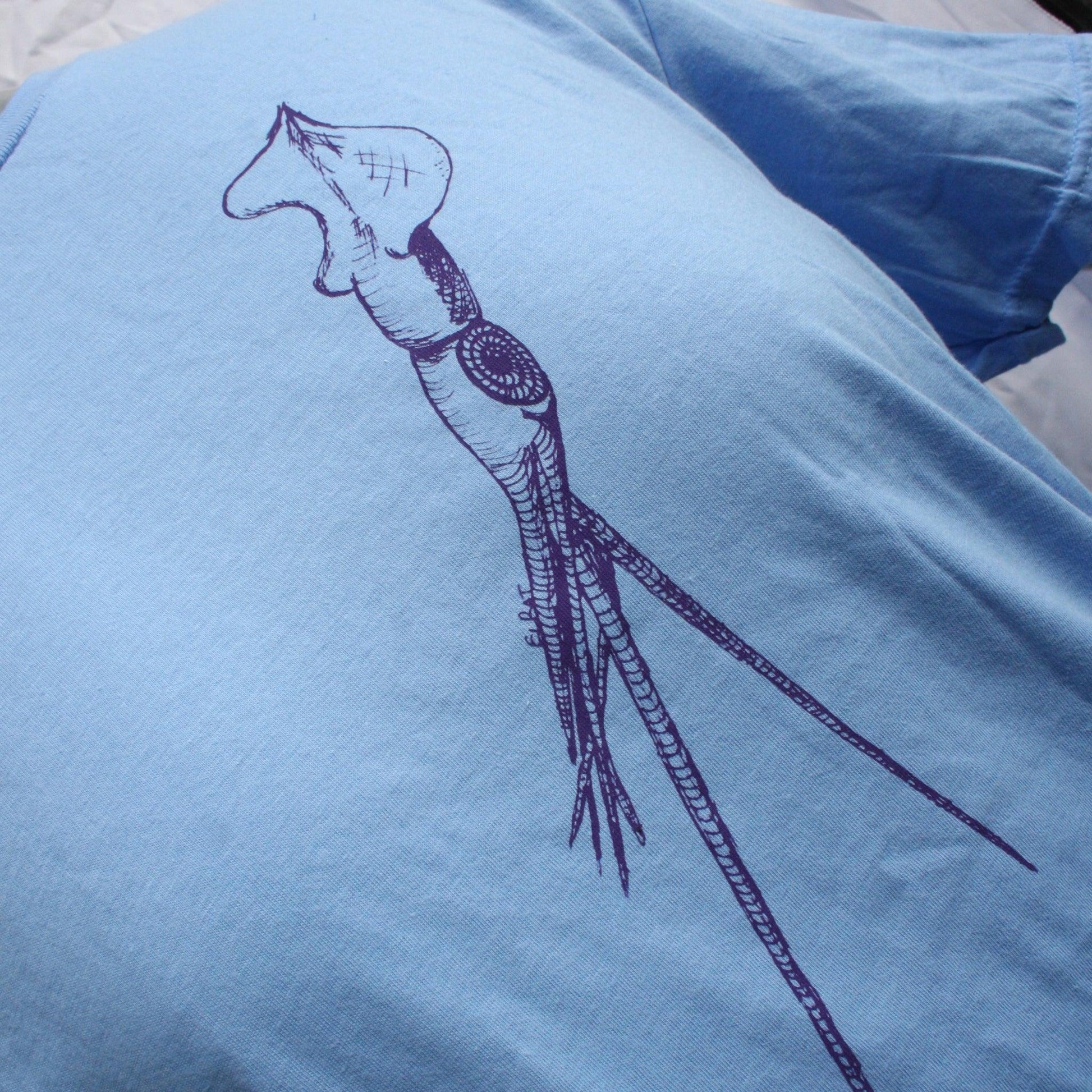 Caroline blue T-shirt featuring a hand-drawn whiplash squid design, with intricate tentacle details and artistic lines.
