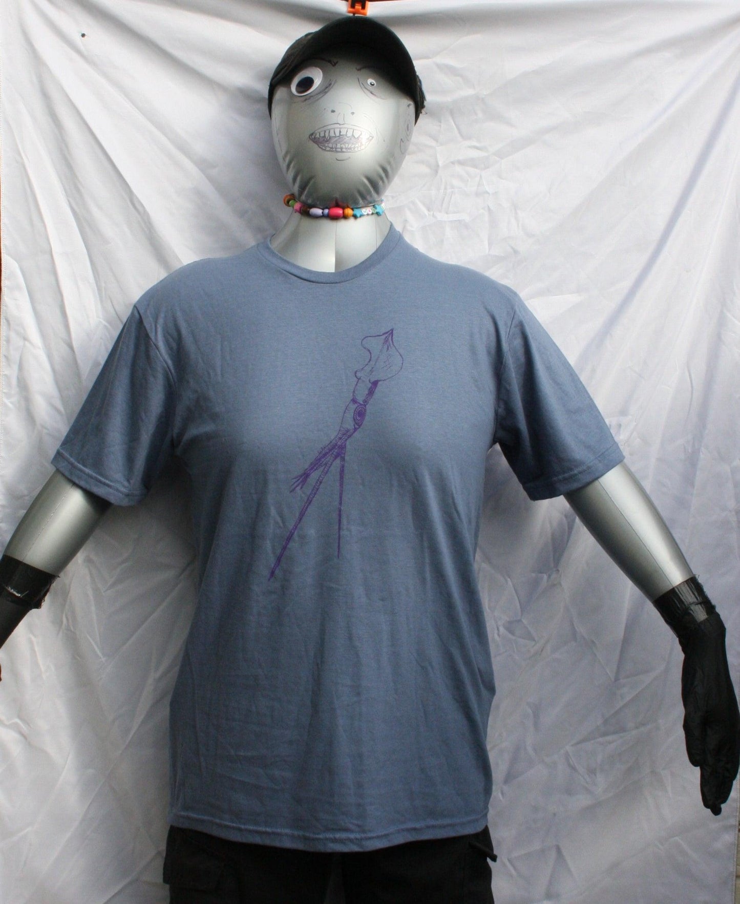 Indigo T-shirt featuring a hand-drawn whiplash squid design, with intricate tentacle details and artistic lines.