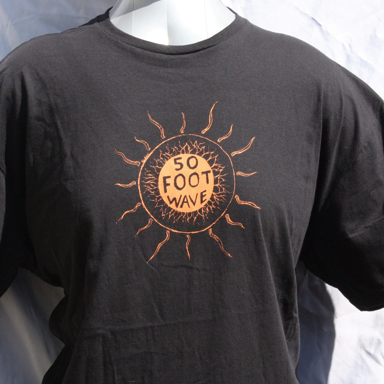 50 Foot Wave 'Staring into the Sun' hand-printed tee by ElRat Designs, showcasing vibrant band shirt on high-quality cotton fabric. Unique design with eco-friendly ink.