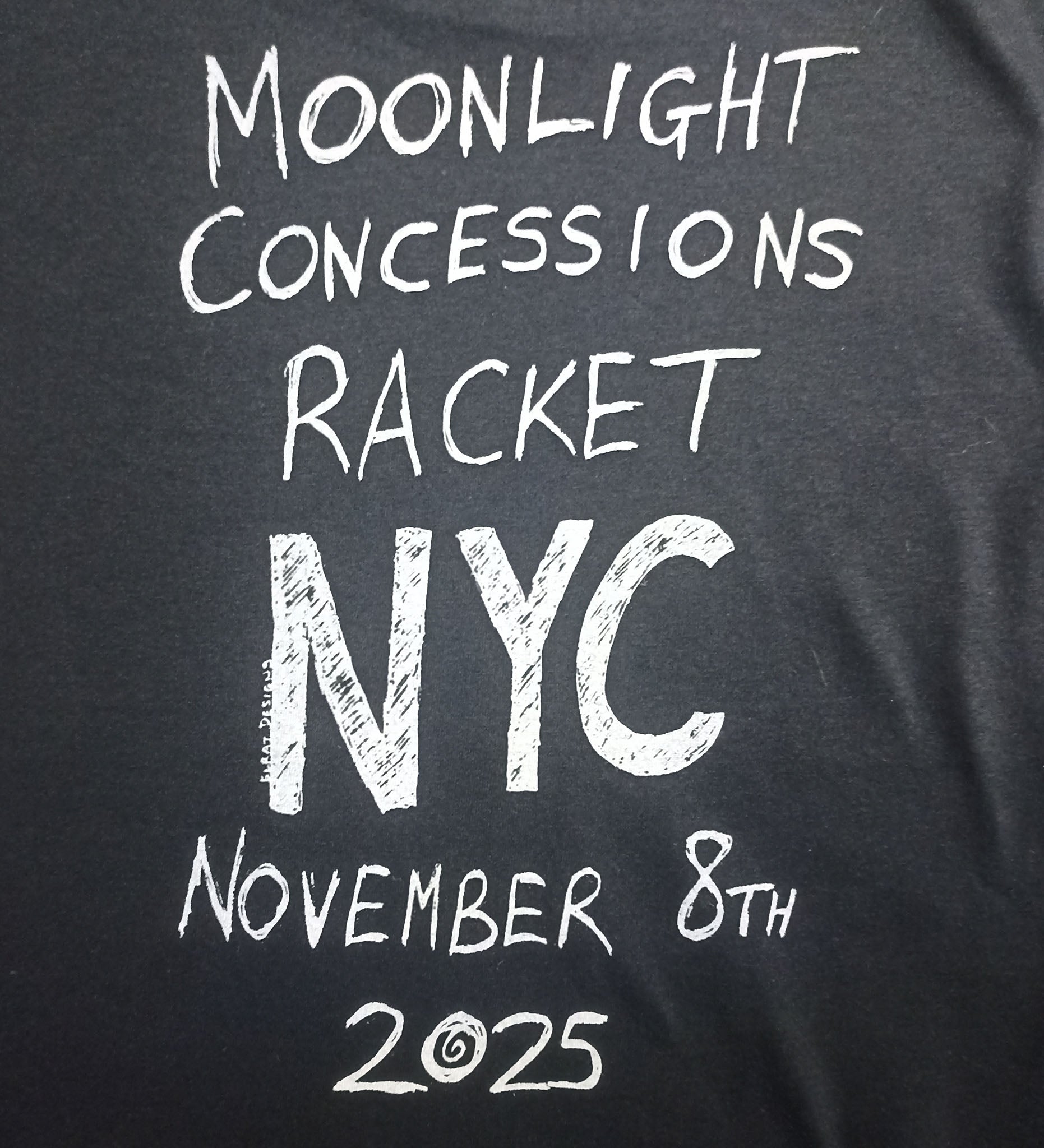 Black t-shirt with white text 'Moonlight Concessions Racket NYC November 8th 2025' on a black background