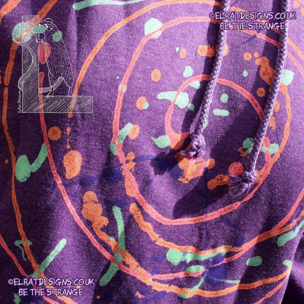 Purple hoodie with a one of a kind Splatter Print spiral SP-MP-Hd-P-S1 using some UV ink, part of a mirrored pair "MC-Splatter001" by ElRat Designs - elratdesigns.co.uk