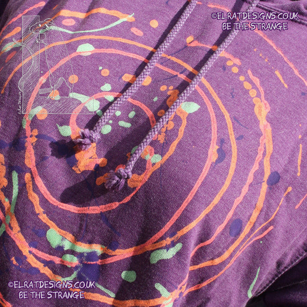 Purple hoodie with a one of a kind Splatter Print spiral SP-MP-Hd-P-S1 using some UV ink, part of a mirrored pair "MC-Splatter001" by ElRat Designs - elratdesigns.co.uk