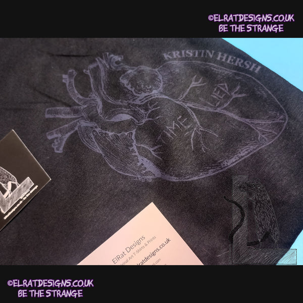 ElRat package of light 2, close up. Kristin Hersh - Reflections on the Motive Power of Fire, "Time Lied" anatomical heart T-shirt, Black Heart Edition, by ElRat designs - hero - elratdesigns.co.uk