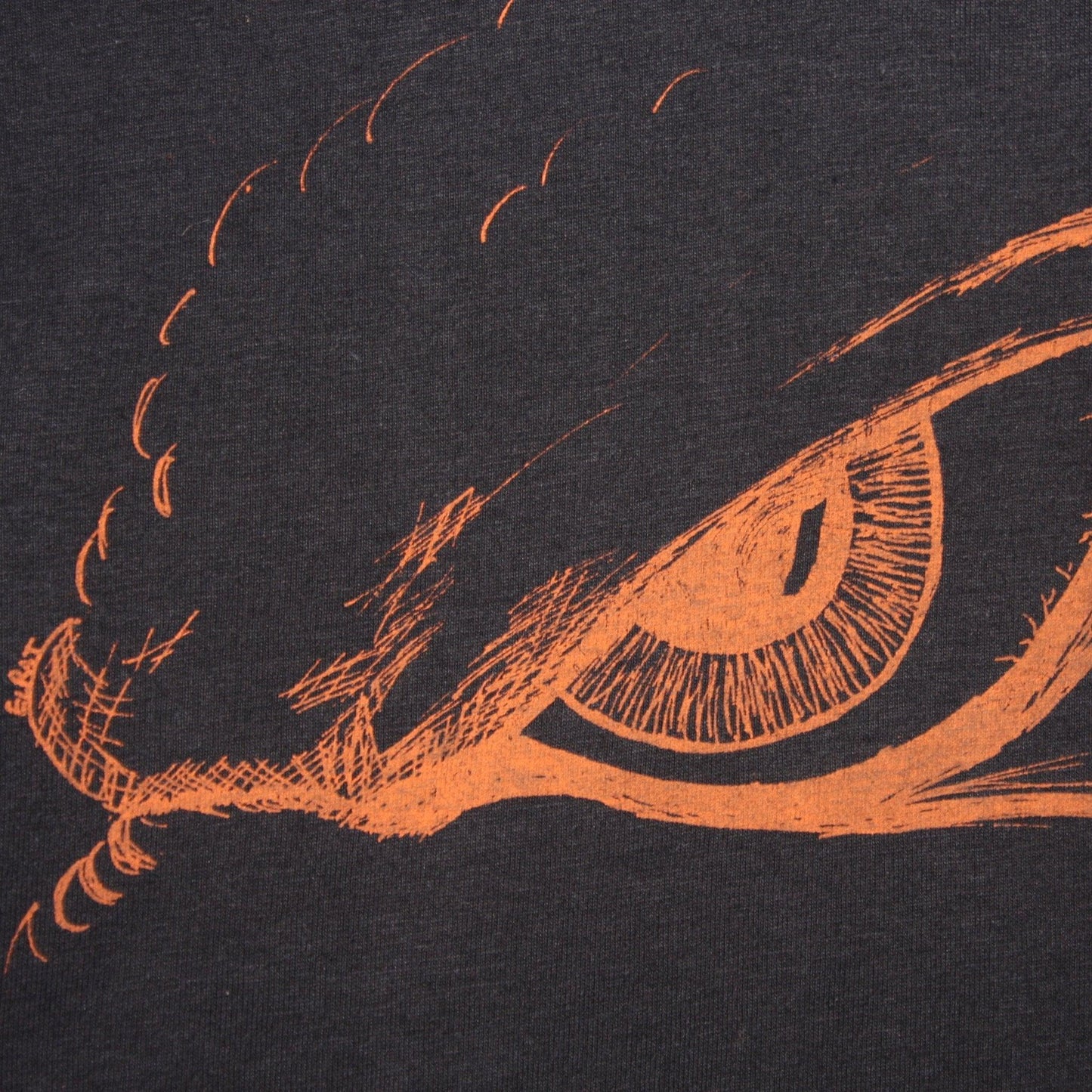 Hand-drawn Kaiju eye design on a screen-printed t-shirt, inspired by Japanese monster movies.