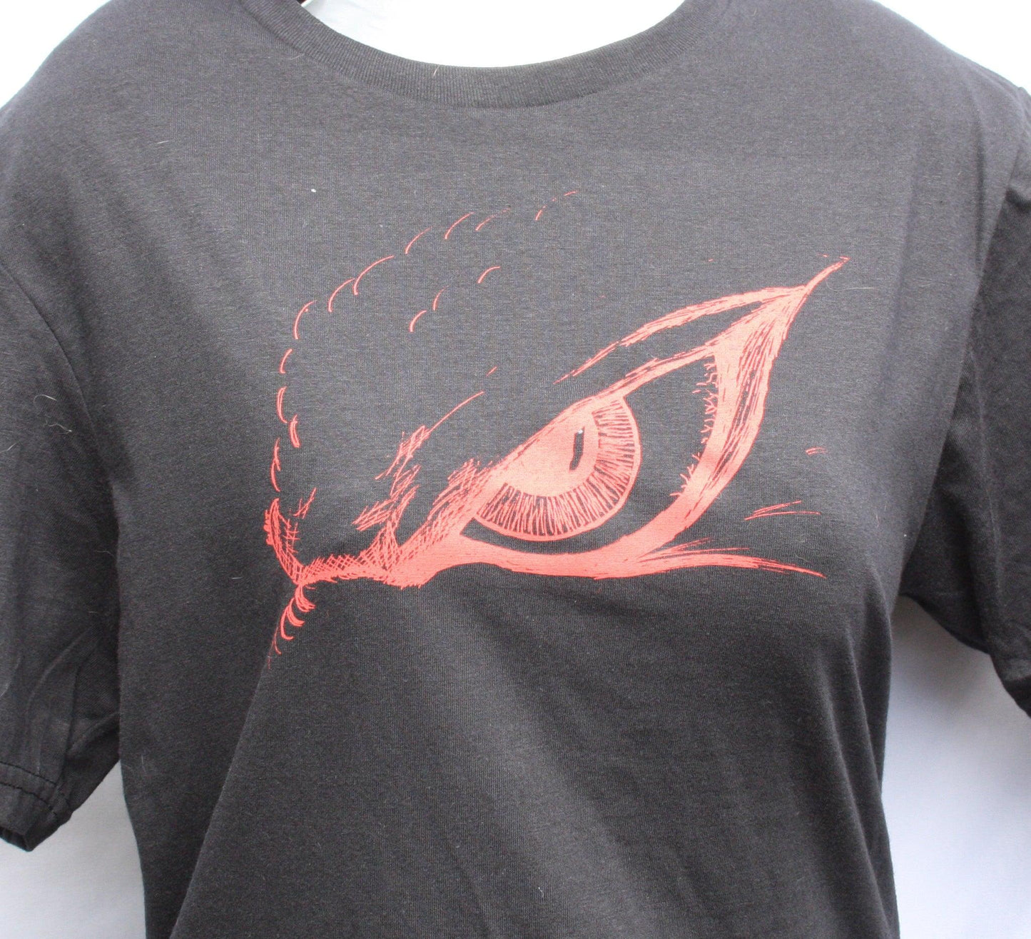 Hand-drawn Kaiju eye design on a screen-printed t-shirt, inspired by Japanese monster movies.