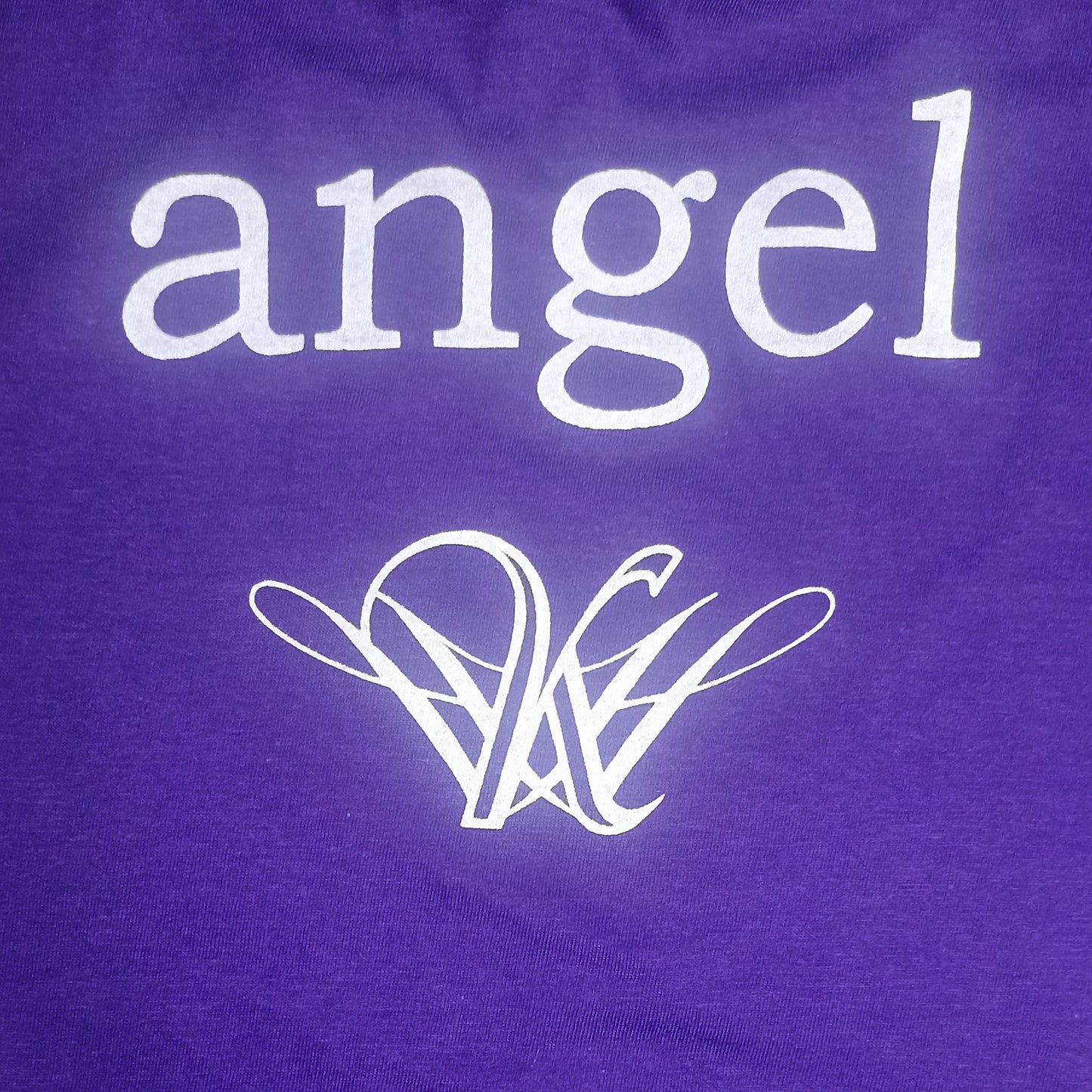 Strange angel exclusive Purple shirt with 'angel' text and logo on a purple background