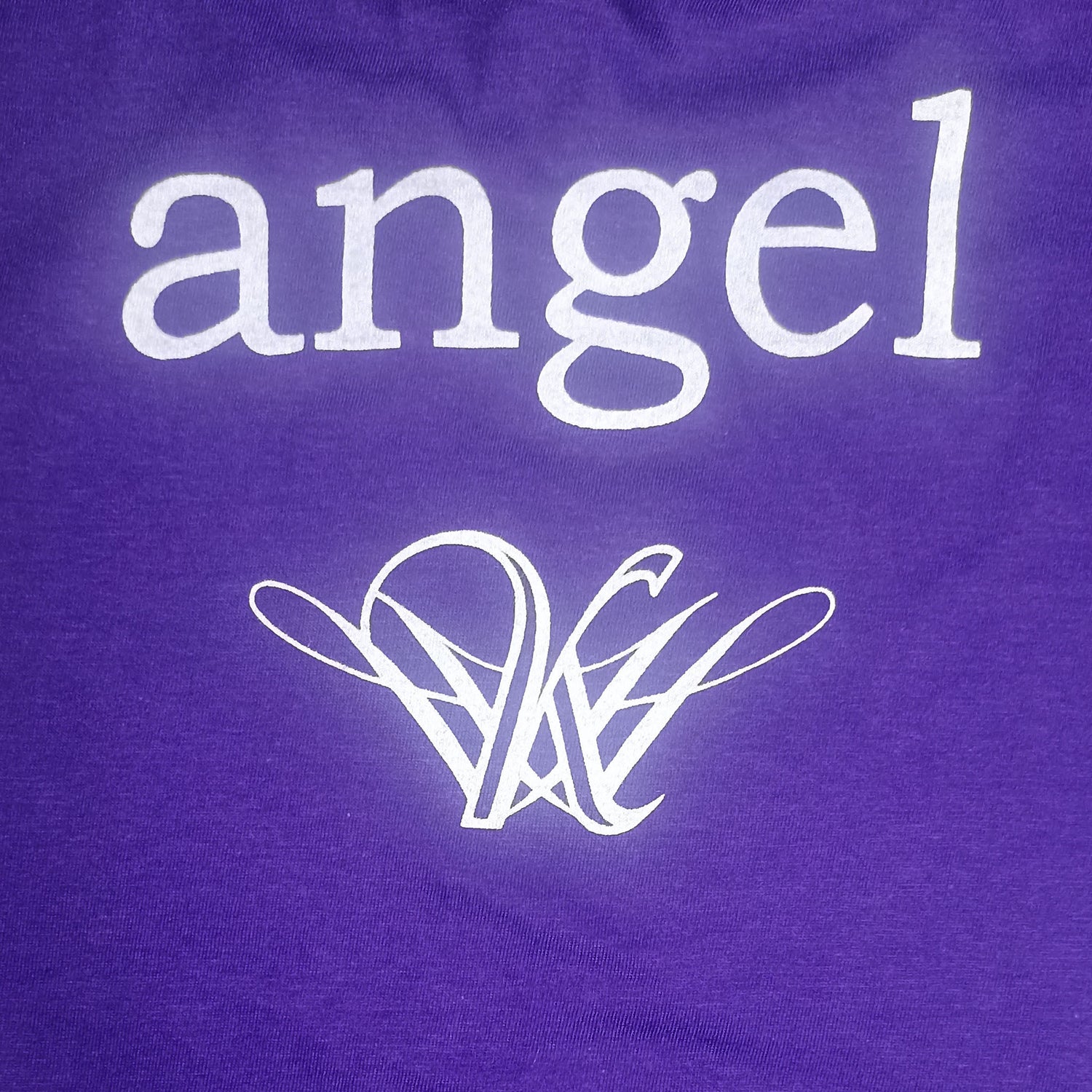 Strange angel exclusive Purple shirt with 'angel' text and logo on a purple background
