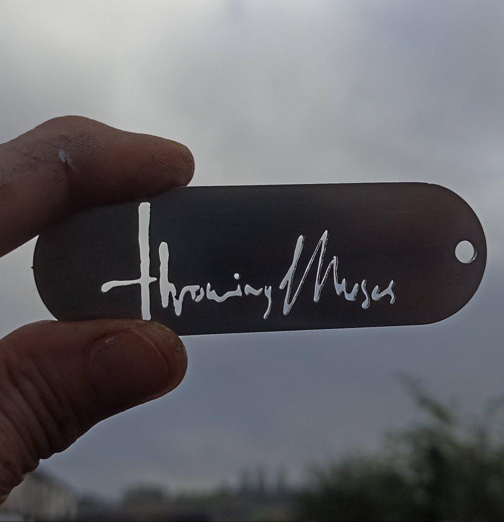 Close-up of the Throwing Muses 1986 logo etched in stainless steel, precision CNC laser-cut for a sharp, finish.